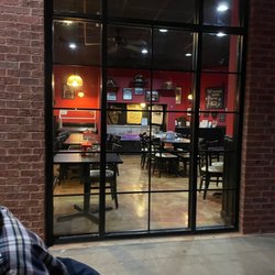 Fox's Pizza Den - View of the inside from outside table