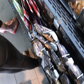 Starbucks - a person standing in front of a display of snacks - Coffee & Tea Near Me - Pickering, Ontario