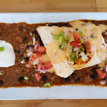 Longboards East Beach - Overloaded chicken burrito - chicken, guac, olives & shredded cheese, queso, pico, sour cream & served on top of black bean chili. - Seafood Near Me - Norfolk, Virginia Longboards East Beach - Overloaded chicken burrito - chicken, guac, olives & shredded cheese, queso, pico, sour cream & served on top of black bean chili. - Seafood Near Me - Norfolk, Virginia