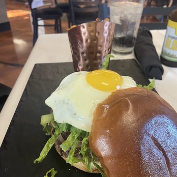 Home Town Hub - Burger with sunny side egg and caramelized onions! Delish and fries were crispy and Seasoned well! - New American Near Me - Corning, California