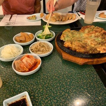 Young's Korean Restaurant - The side dishes are called banchan and with a seafood pancake make a tasty start to the meal. All are meant to be shared. - Korean Near Me - Rochester, New York Young's Korean Restaurant - The side dishes are called banchan and with a seafood pancake make a tasty start to the meal. All are meant to be shared. - Korean Near Me - Rochester, New York