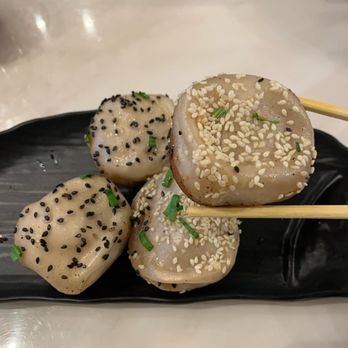 Yang’s Dumpling - three dumplings on a black plate with chopsticks - Dumplings Near Me - Toronto, Ontario Yang’s Dumpling - three dumplings on a black plate with chopsticks - Dumplings Near Me - Toronto, Ontario
