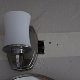 Light in the bathroom has an open hole where you can see the electrical wiring exposed