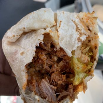 Malena Tacos - a hand holding a burrito - Mexican Near Me - Dallas, Texas Malena Tacos - a hand holding a burrito - Mexican Near Me - Dallas, Texas