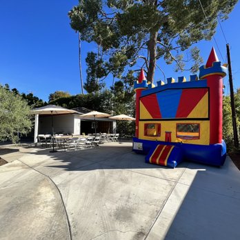 Otay Party Rentals - Standard castle bouncy house, some of the tables and umbrellas - Party Equipment Rentals Near Me