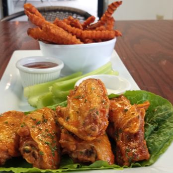 Chef Shaqs Kitchen - a plate of chicken wings and lettuce - American Near Me - Louisville, Kentucky