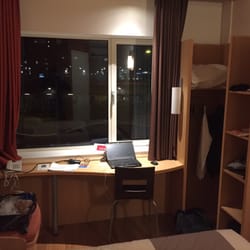 Hotel Ibis Leiden Centre - View of the desk from the door.  Small open wardrobe to the right.