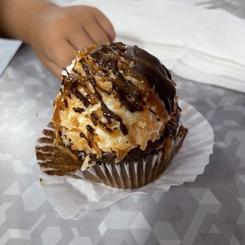 Karma Cakes - a hand reaching for a cupcake - Cupcakes Near Me - Leavenworth, Kansas Karma Cakes - a hand reaching for a cupcake - Cupcakes Near Me - Leavenworth, Kansas