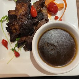 Ribs with hoisin sauce on the side. Ribs with hoisin sauce on the side.