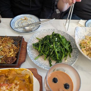 Uncle Cha Fusion Cafe - Sizzling Beef Satay Noodles on the left and stir fry garlic pea sprouts at the center - Asian Fusion Near Me - Milpitas, California Uncle Cha Fusion Cafe - Sizzling Beef Satay Noodles on the left and stir fry garlic pea sprouts at the center - Asian Fusion Near Me - Milpitas, California