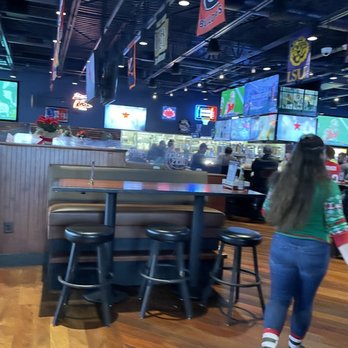 Kickback Jack's - a woman walking through a sports bar - Sports Bars Near Me - High Point, North Carolina Kickback Jack's - a woman walking through a sports bar - Sports Bars Near Me - High Point, North Carolina