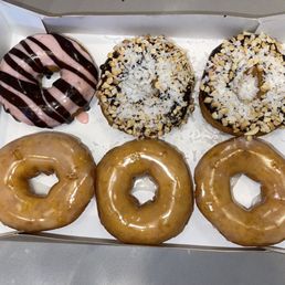 Six donuts: 3 glazes, 2 chocolate with coconut and peanuts, 1 strawberry with chocolate drizzle. Six donuts: 3 glazes, 2 chocolate with coconut and peanuts, 1 strawberry with chocolate drizzle.