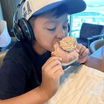 Donutique - My sweetie, enjoying his churro doughnut - Donuts Near Me - Las Vegas, Nevada