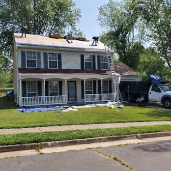 Real 1 Construction - a house with a truck parked in front of it - Roofing Near Me