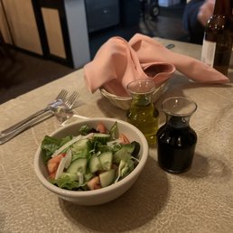 a bowl of salad and a bottle of wine a bowl of salad and a bottle of wine