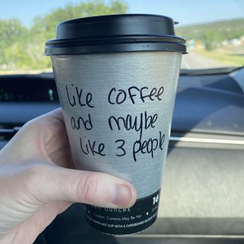 Kaffee Klatsch - a hand holding a cup of coffee - Coffee & Tea Near Me - Newcastle, Wyoming