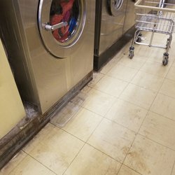 Mt Hope Cleaners & Coin Laundry - Machine leaki g water all over the floor. Notice the cheap plastic tray to catxh the water...yet no sign on machine warning not to use it