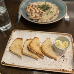 Cedar + Stone, Urban Table - In the foreground- gluten free toast with salted butter. In the background- mushroom risotto with chicken.