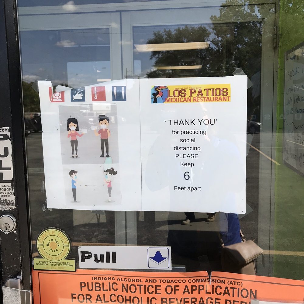Los Patios - a sign on the door of a restaurant - Mexican Near Me - Indianapolis, Indiana