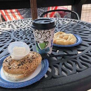 Wicked Espresso - a cup of coffee and a bagel on a table - Coffee & Tea Near Me - Custer, South Dakota