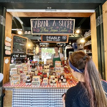 Marche Place Jacques - a woman standing in front of a store - Farmers Market Near Me - Montreal, Quebec Marche Place Jacques - a woman standing in front of a store - Farmers Market Near Me - Montreal, Quebec