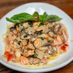 Portofino Restaurant & Bar - Creamy shrimp pasta with basil, mushrooms, and a touch of tomato--comfort with a gourmet twist.