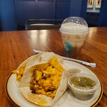 White Rhino Coffee - 2 chorizo tacos with green salsa and a sweet foam cold brew with splash of coconut milk. In front of cafe background. - Coffee & Tea Near Me - Garland, Texas White Rhino Coffee - 2 chorizo tacos with green salsa and a sweet foam cold brew with splash of coconut milk. In front of cafe background. - Coffee & Tea Near Me - Garland, Texas