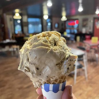 Muskie Waters - a hand holding a cone of ice cream - Coffee & Tea Near Me - Nevis, Minnesota Muskie Waters - a hand holding a cone of ice cream - Coffee & Tea Near Me - Nevis, Minnesota