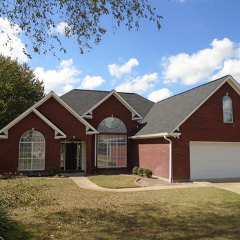 Witten Roofing - a brick house with a garage - General Contractors Near Me - West Monroe, Louisiana