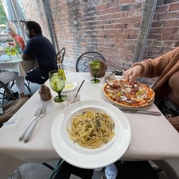 a plate of pasta and a pizza a plate of pasta and a pizza