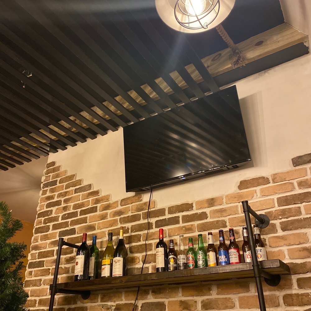 a television mounted on a brick wall