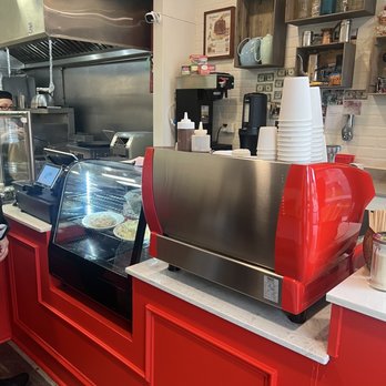 Launch Room cafe - a man standing in front of the counter - Caterers Near Me