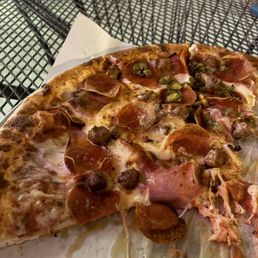 Medium meat pizza with added jalapeño on half Medium meat pizza with added jalapeño on half