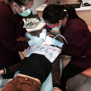 Moraga Pediatric Dentistry - Dr. Cheung working hard while my son relaxes and watches Big Hero 6 on the ceiling screen. He's totally relaxed as they replace a filling. - Pediatric Dentists Near Me - Moraga, California Moraga Pediatric Dentistry - Dr. Cheung working hard while my son relaxes and watches Big Hero 6 on the ceiling screen. He's totally relaxed as they replace a filling. - Pediatric Dentists Near Me - Moraga, California
