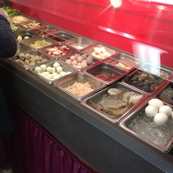 Four Seasons Hot Pot And Dumpling - a woman standing in front of a buffet - Chinese Near Me - Provo, Utah