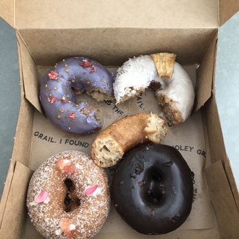 Holey Grail Donuts - Making our way through the flavors! Clockwise from top left: Birthday Cake, The Haole, Hot Single, Chocolate Crunch, L&L. - Donuts Near Me - Honolulu, Hawaii Holey Grail Donuts - Making our way through the flavors! Clockwise from top left: Birthday Cake, The Haole, Hot Single, Chocolate Crunch, L&L. - Donuts Near Me - Honolulu, Hawaii