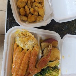Gator bites and crab leg plate with potato and brocolli Gator bites and crab leg plate with potato and brocolli