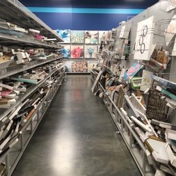 What is supposed to be an aisle of canvas and framed art