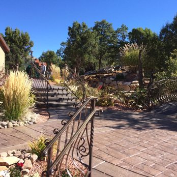 Frontier Outdoors - a stone patio with steps leading up to a house - Landscaping Near Me - Morrison, Colorado Frontier Outdoors - a stone patio with steps leading up to a house - Landscaping Near Me - Morrison, Colorado