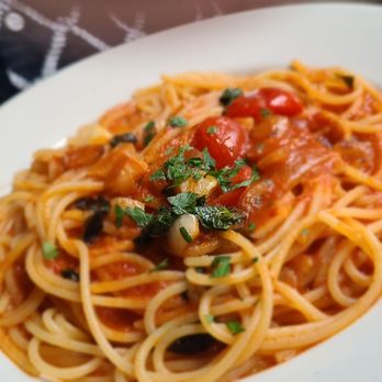 Bacaro - a plate of spaghetti with tomato sauce - Italian Near Me - New York, New York