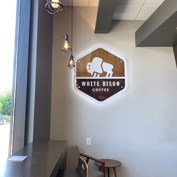 White Bison Coffee - a table and chairs in a coffee shop - Gas Stations Near Me - Murfreesboro, Tennessee