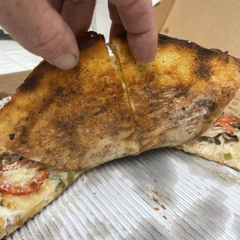 Village Pizza - a hand picking up a piece of pizza - Pizza Near Me - Bonsall, California Village Pizza - a hand picking up a piece of pizza - Pizza Near Me - Bonsall, California