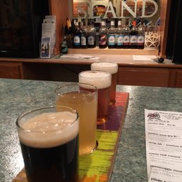 a row of beer glasses on a bar