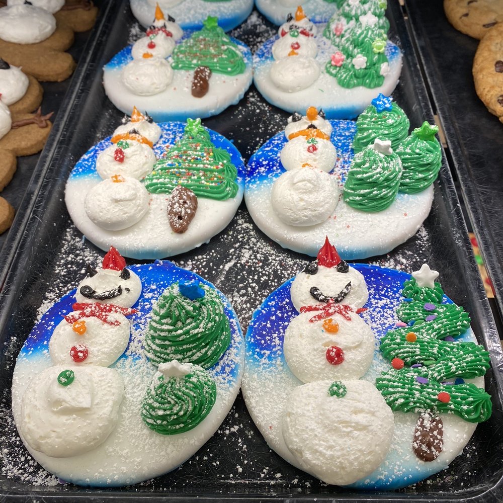 a tray of frosted snowman cookies a tray of frosted snowman cookies