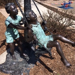 Diecke Discovery Zone - Statue by swing sets.