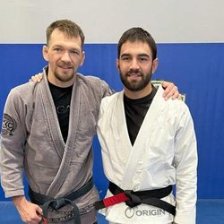 Zingano BJJ Brighton - Professor Jordan Blanco and Professor Cory Kuechler, both wearing Brazilian Jiu-Jitsu gis and black belts, posing together on...