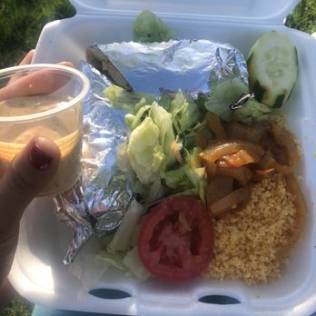 Balabe - a person holding a container of food - Food Trucks Near Me Balabe - a person holding a container of food - Food Trucks Near Me