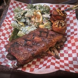 Ribs, brisket, and chicken with bacon wrapped corn and a Caesar salad