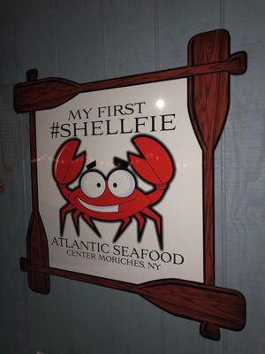 Photo of Atlantic Seafood - Center Moriches, NY, US. a crab and oars on a sign