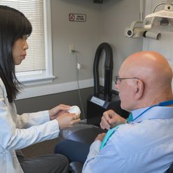 Hopewell Family Dentistry - Dr. Minkyeong Son explaining a dental model to a patient during a consultation at Hopewell Family Dentistry, focusing on patient education a